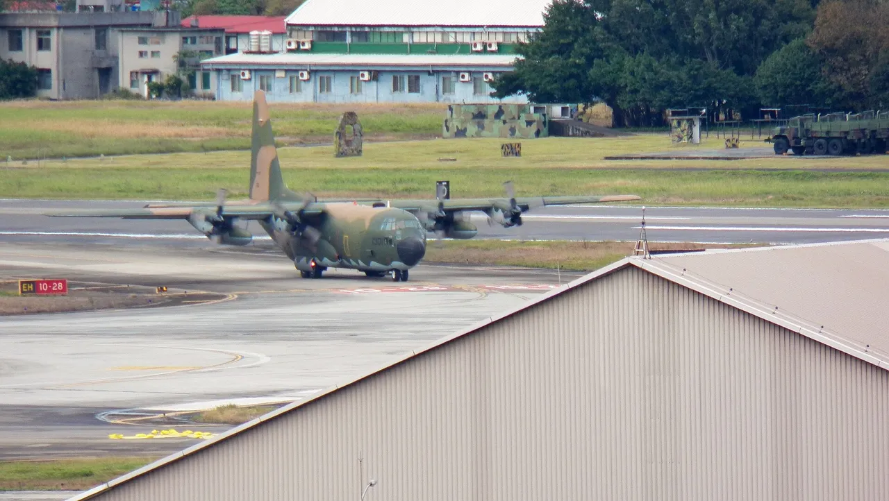 A grey four-engined Taiwanese air force C-130H transport aircraft taxis on a runway