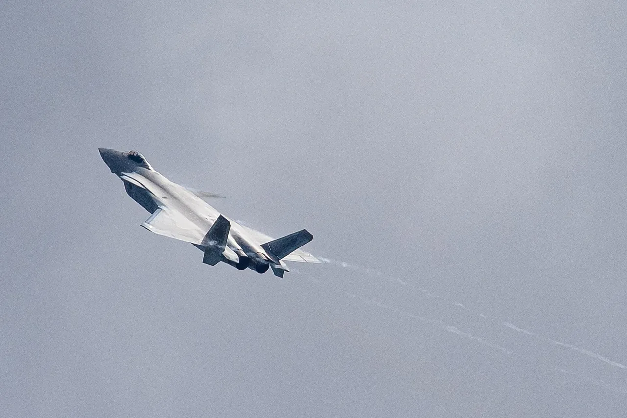 A grey Chinese J-20 stealth fighter climbing steeply against an overcast sky with vapour trailing from its wingtips