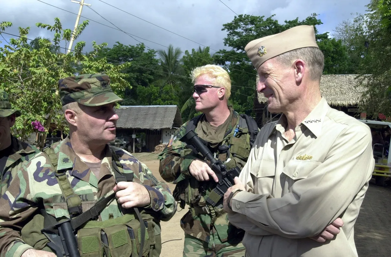US Navy Admiral Dennis Blair talks with US Special Forces personnel outdoors in the Philippines