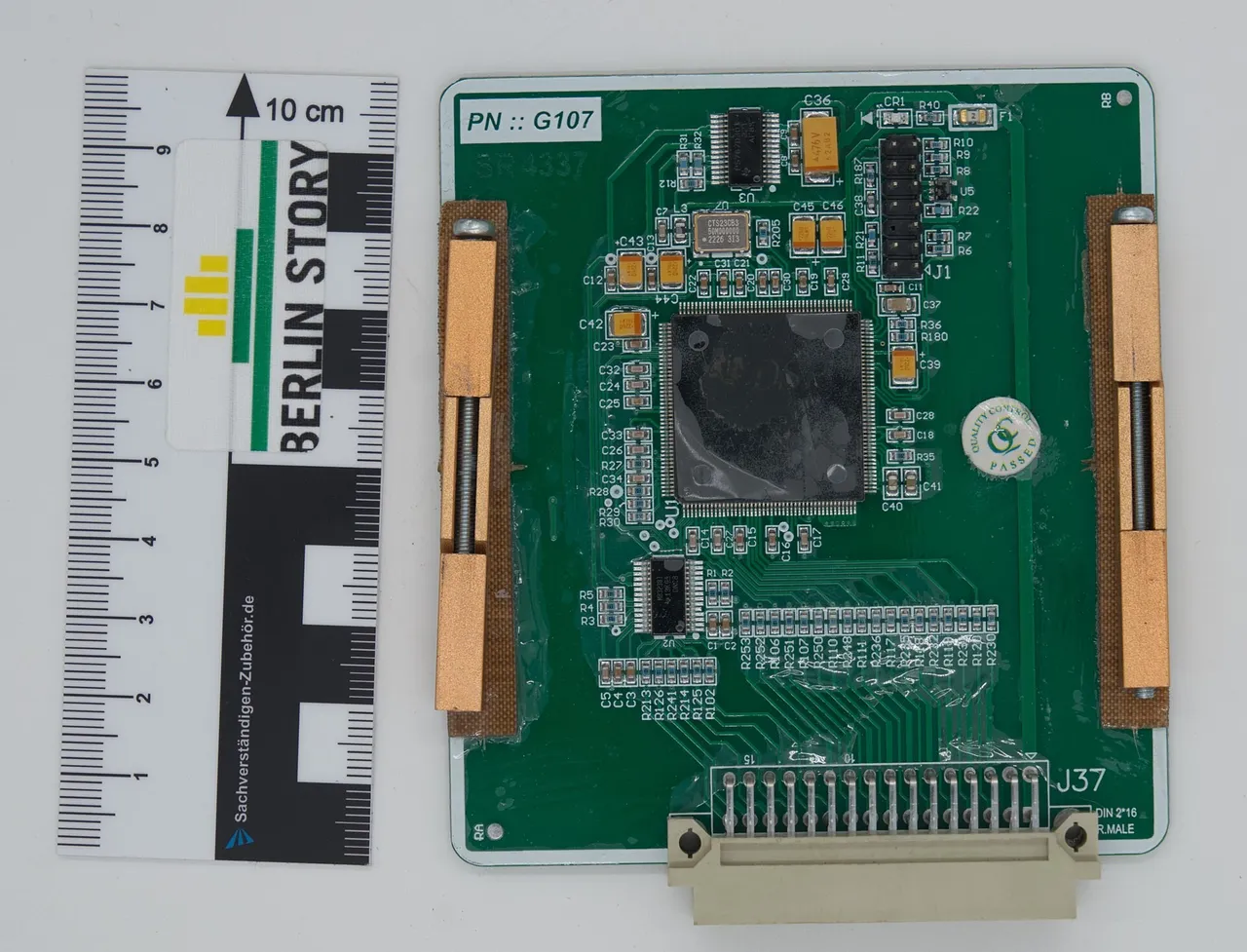 Green circuit board from a Geran-2 drone flight computer beside a 10 cm measuring scale