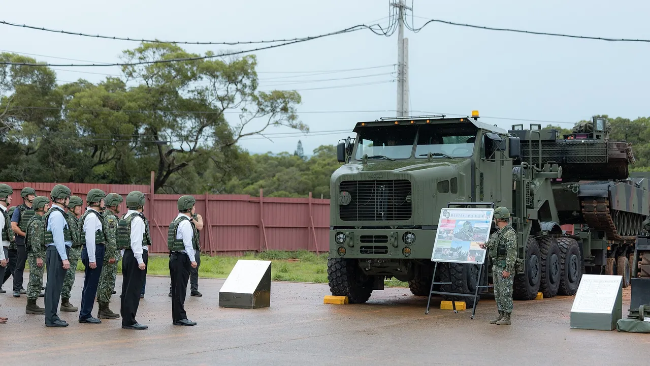 A camouflaged Taiwanese M1A2T Abrams tank on a heavy transporter truck under a cloudy sky