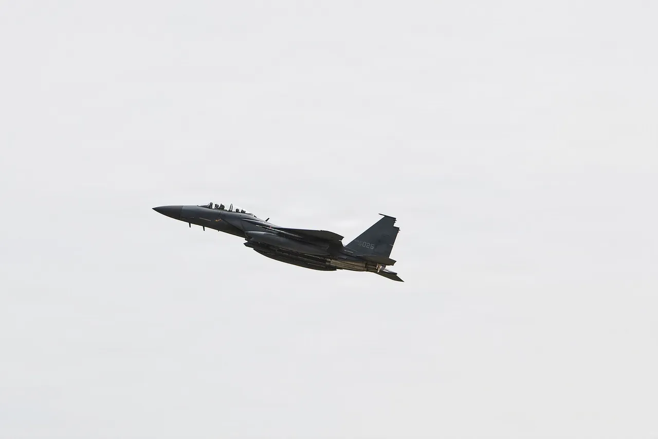 A grey twin-tail South Korean fighter jet climbs into an overcast sky