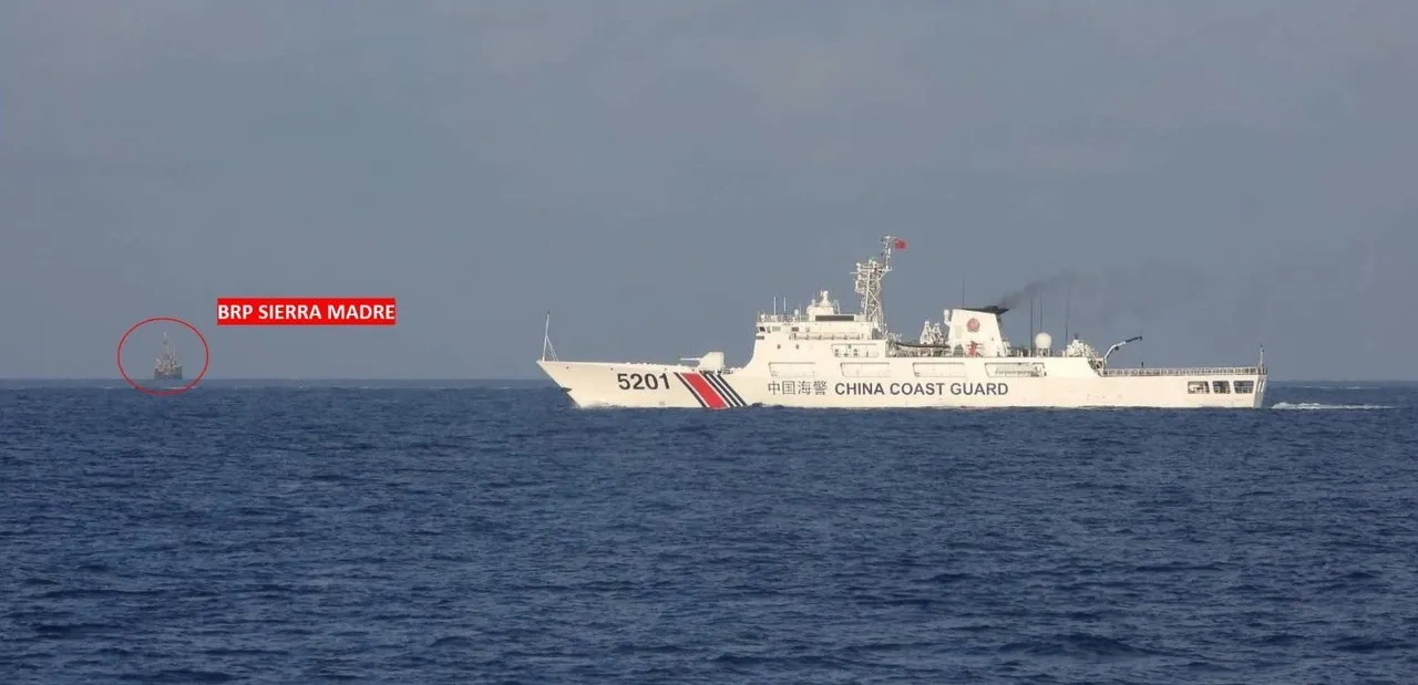 A white China Coast Guard ship sailing close to a smaller white Philippine Coast Guard patrol vessel on open sea