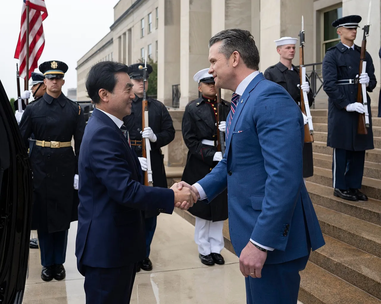 Pete Hegseth and South Korea's then defence minister Ahn Gyu-back meet at the Pentagon with US and South Korean flags behind them