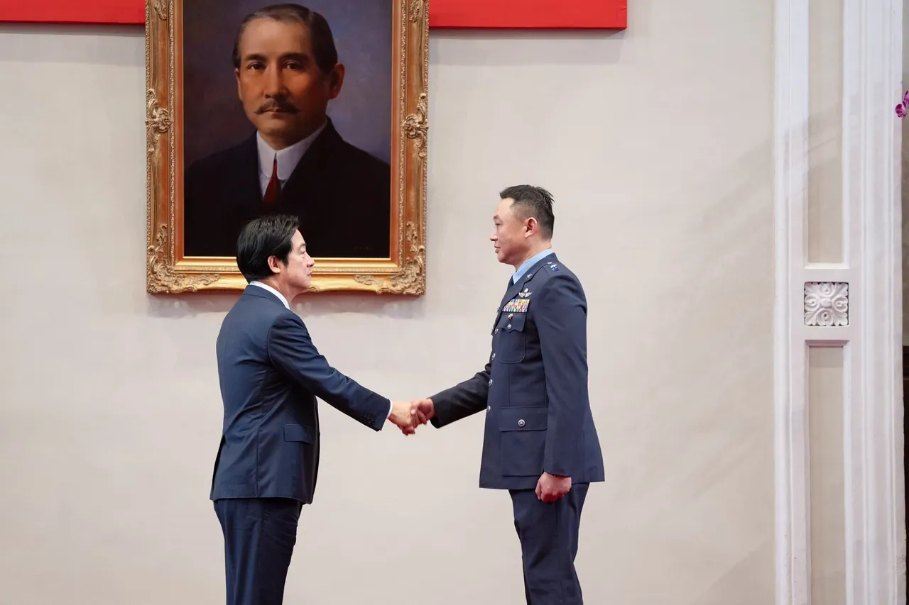 President Lai Ching-te shaking hands with an air force officer in a blue uniform beneath a portrait of Sun Yat-sen