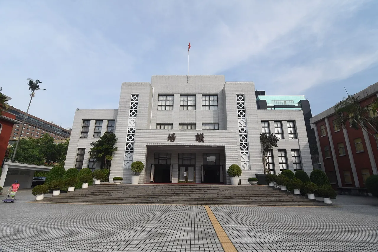 White stone facade of the Legislative Yuan chamber building in Taipei with steps and potted shrubs in front