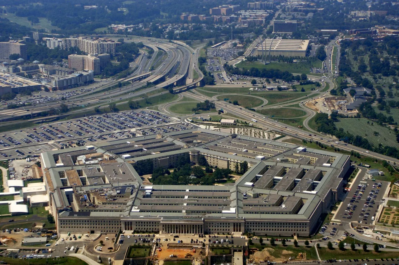 Aerial photograph of the five-sided Pentagon building surrounded by car parks, roads and trees.
