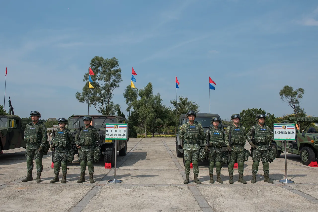 Two groups of Taiwanese soldiers in helmets and camouflage stand in formation in front of military vehicles on a parade ground under a blue sky