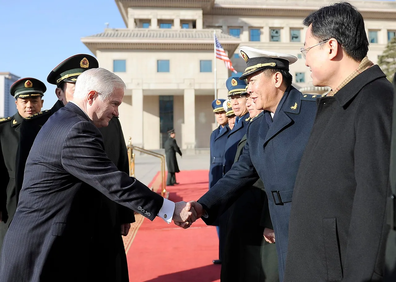 Uniformed Chinese military officers in a receiving line shake hands with a grey-haired man in a dark suit outside a large pale building