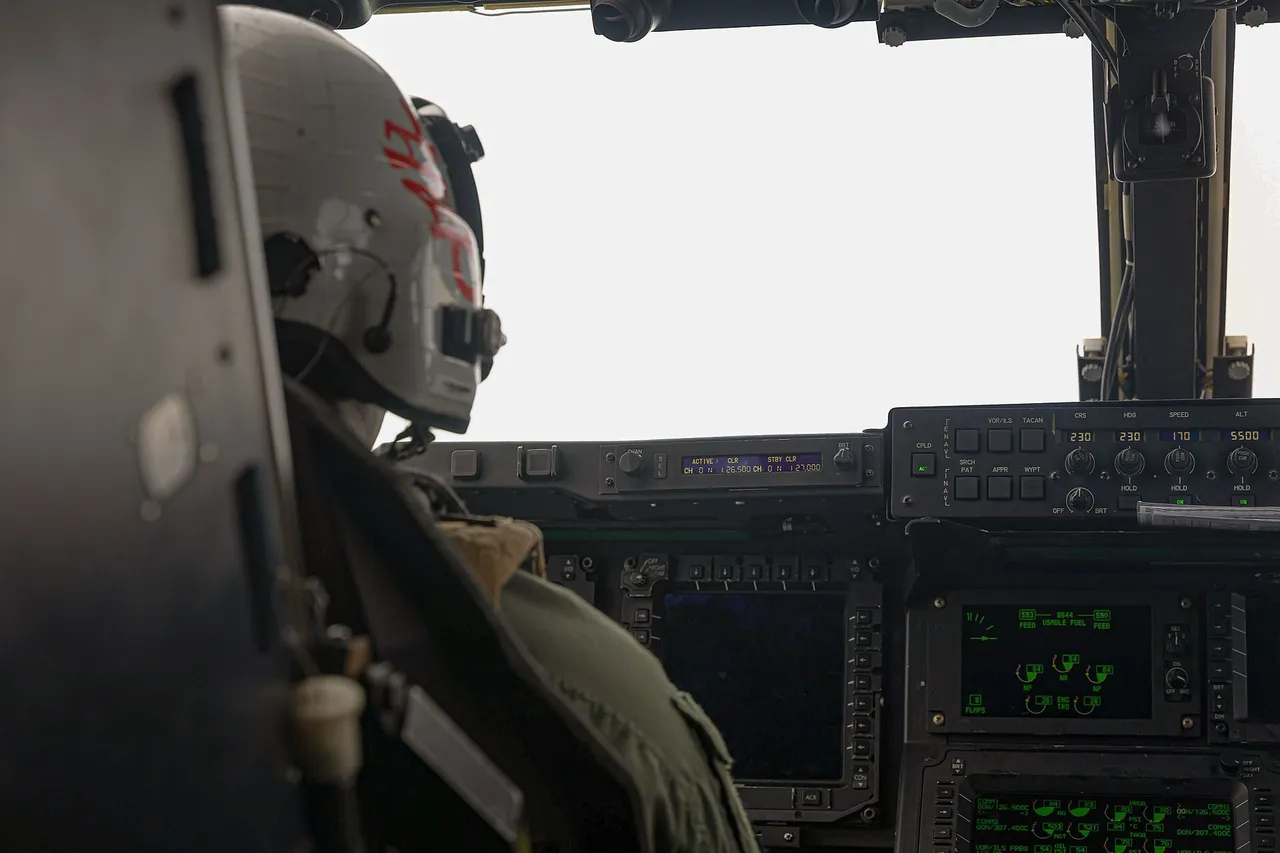 A US Marine Corps MV-22B Osprey tiltrotor aircraft in flight over green hills in Kumamoto, Japan