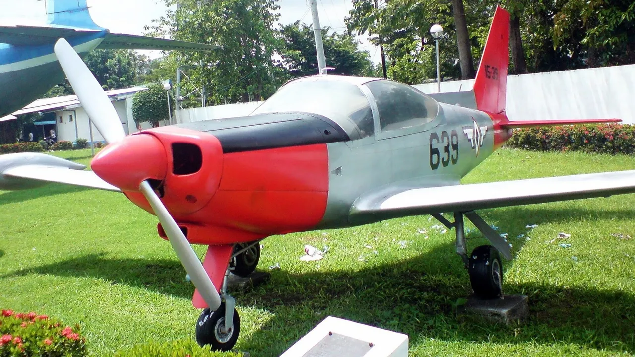 A small single-engine propeller trainer aircraft with a bubble canopy and Philippine Air Force markings parked on a concrete apron