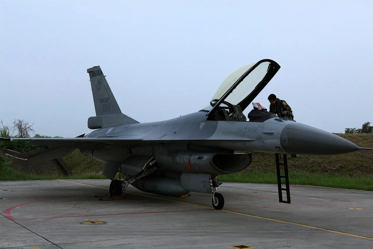 A Taiwanese air force pilot in a flight suit prepares to board an F-16 fighter jet