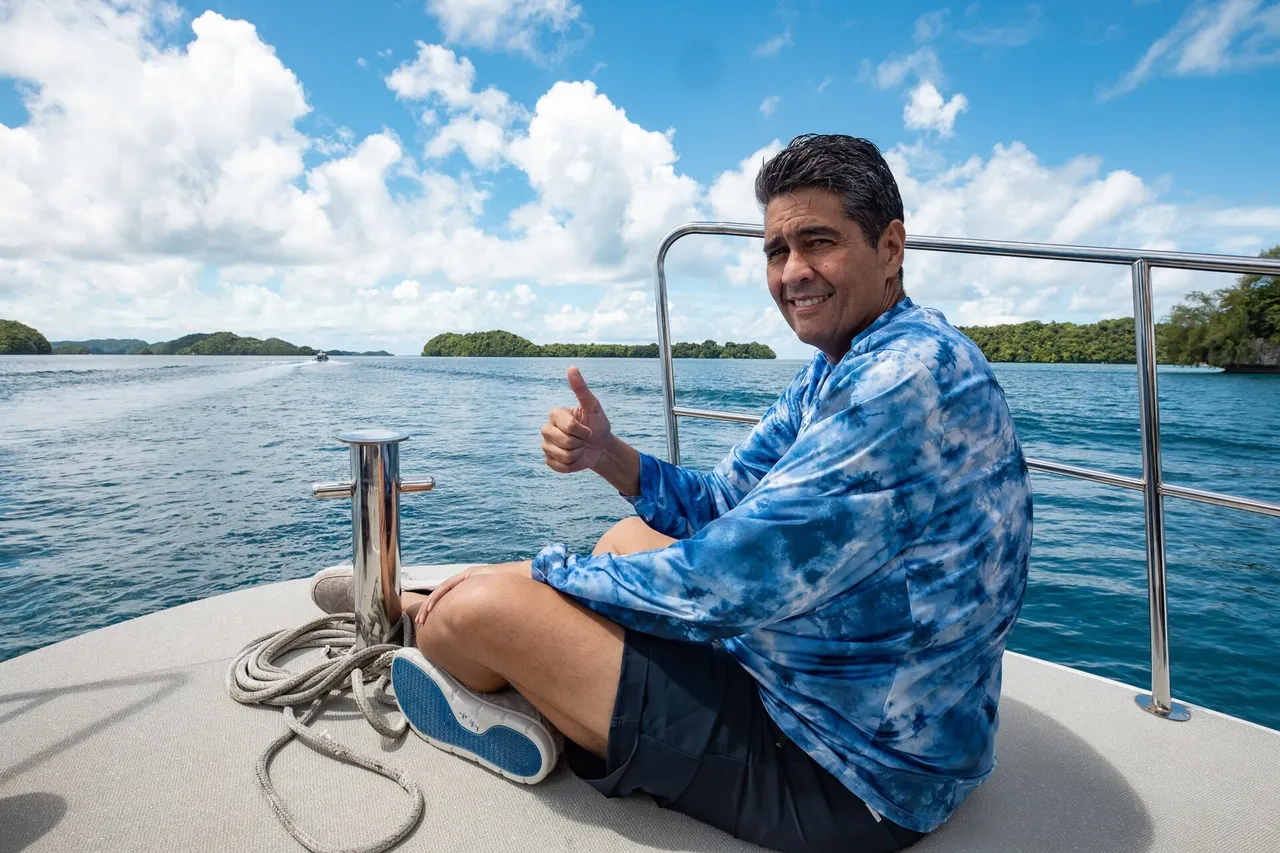 Palau President Surangel Whipps Jr standing outdoors near turquoise lagoon waters and limestone islands