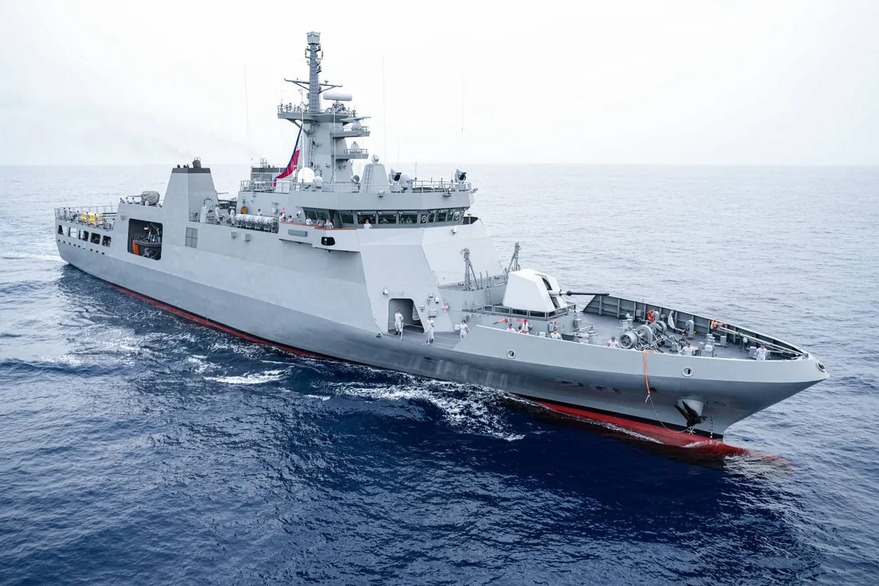 A grey Philippine Navy offshore patrol vessel with a tall mast and a gun turret on its bow sails across dark blue sea