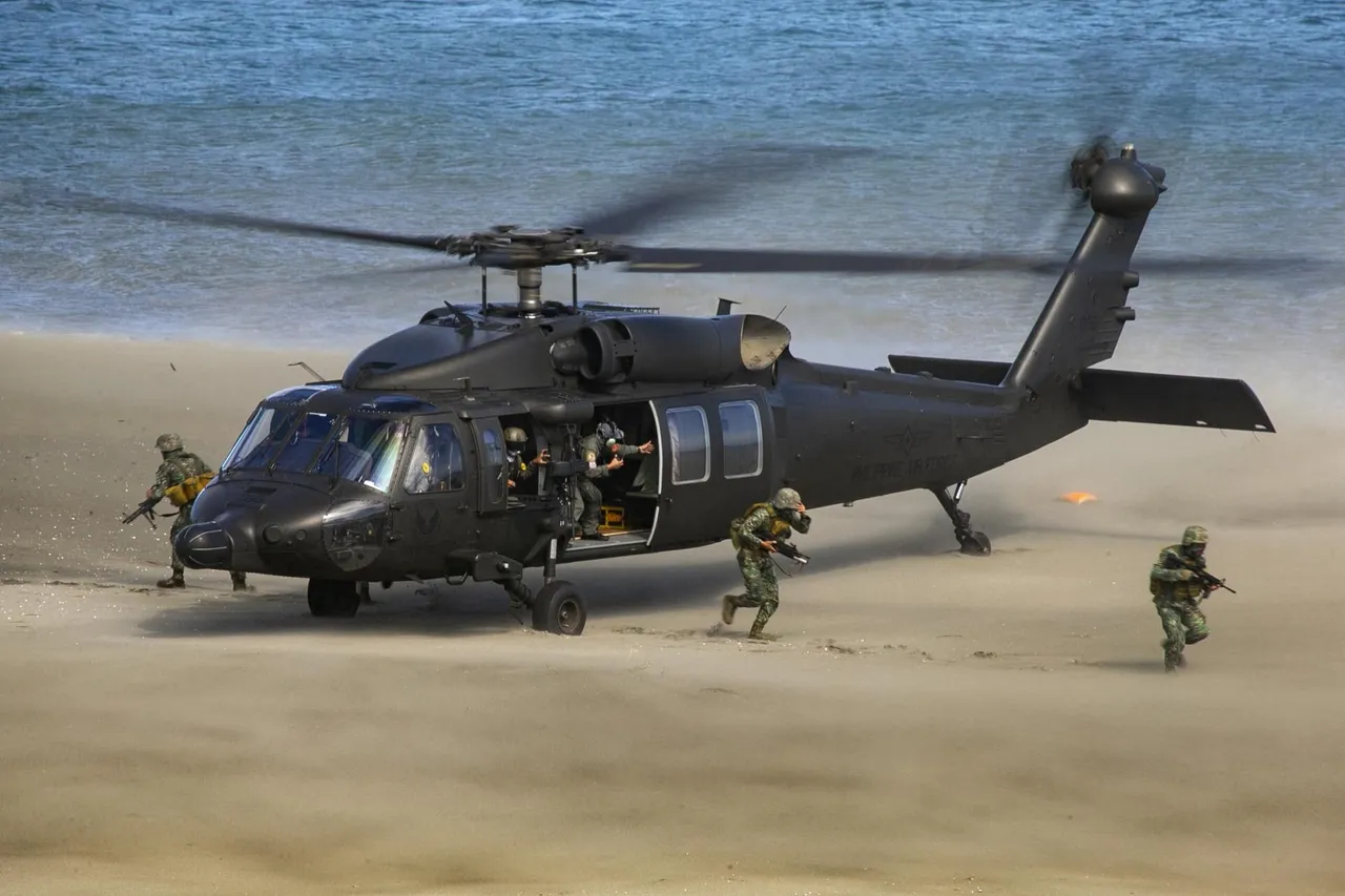 Soldiers in camouflage with rifles run from a dark grey Black Hawk helicopter that has landed on a sandy beach by the sea
