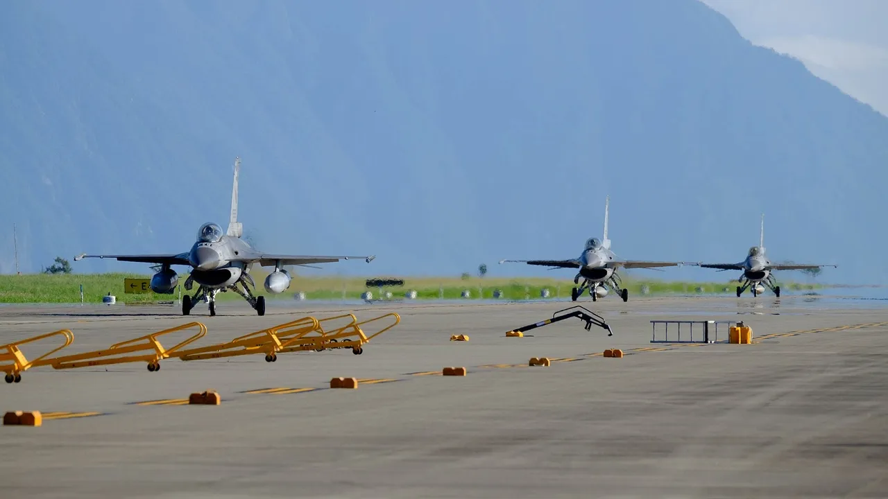 Three grey Taiwanese air force F-16 fighter jets taxiing in line along a runway at Hualien Air Force Base