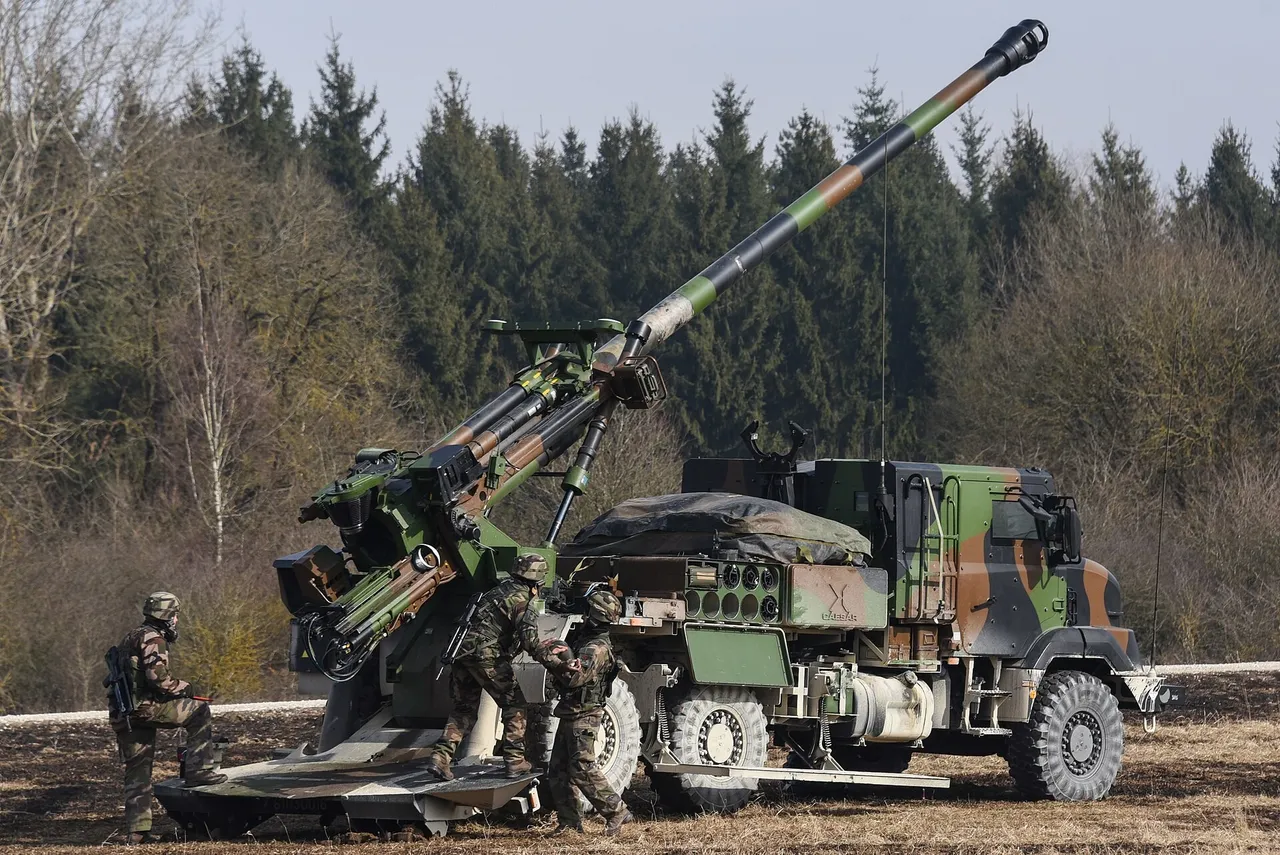 A camouflaged French Army CAESAR truck-mounted howitzer with its barrel raised on a snowy training range