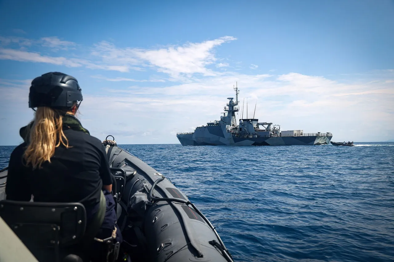 File photo of a rigid inflatable approaching a Royal Navy patrol ship at sea