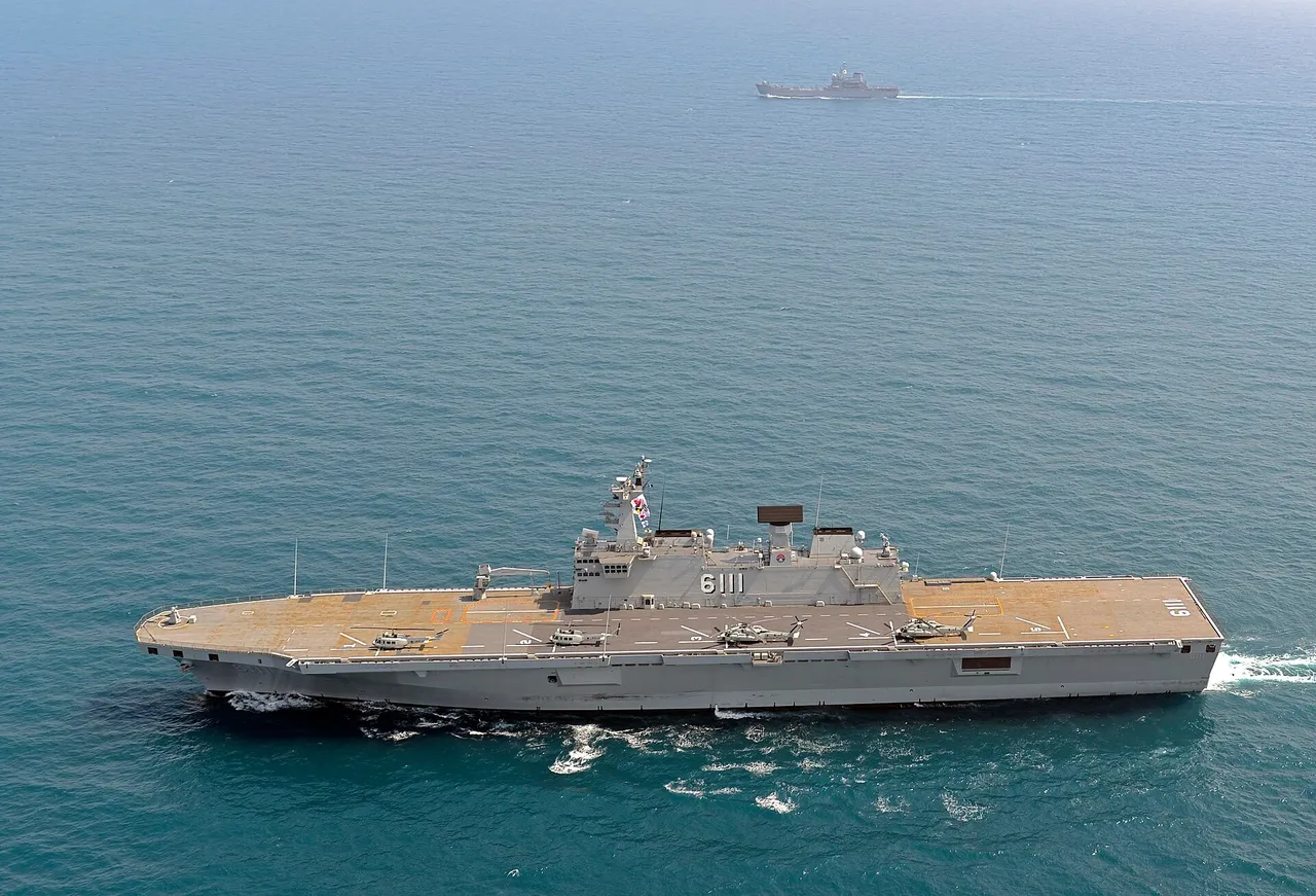 A grey South Korean amphibious assault ship with a flat flight deck sailing on open sea