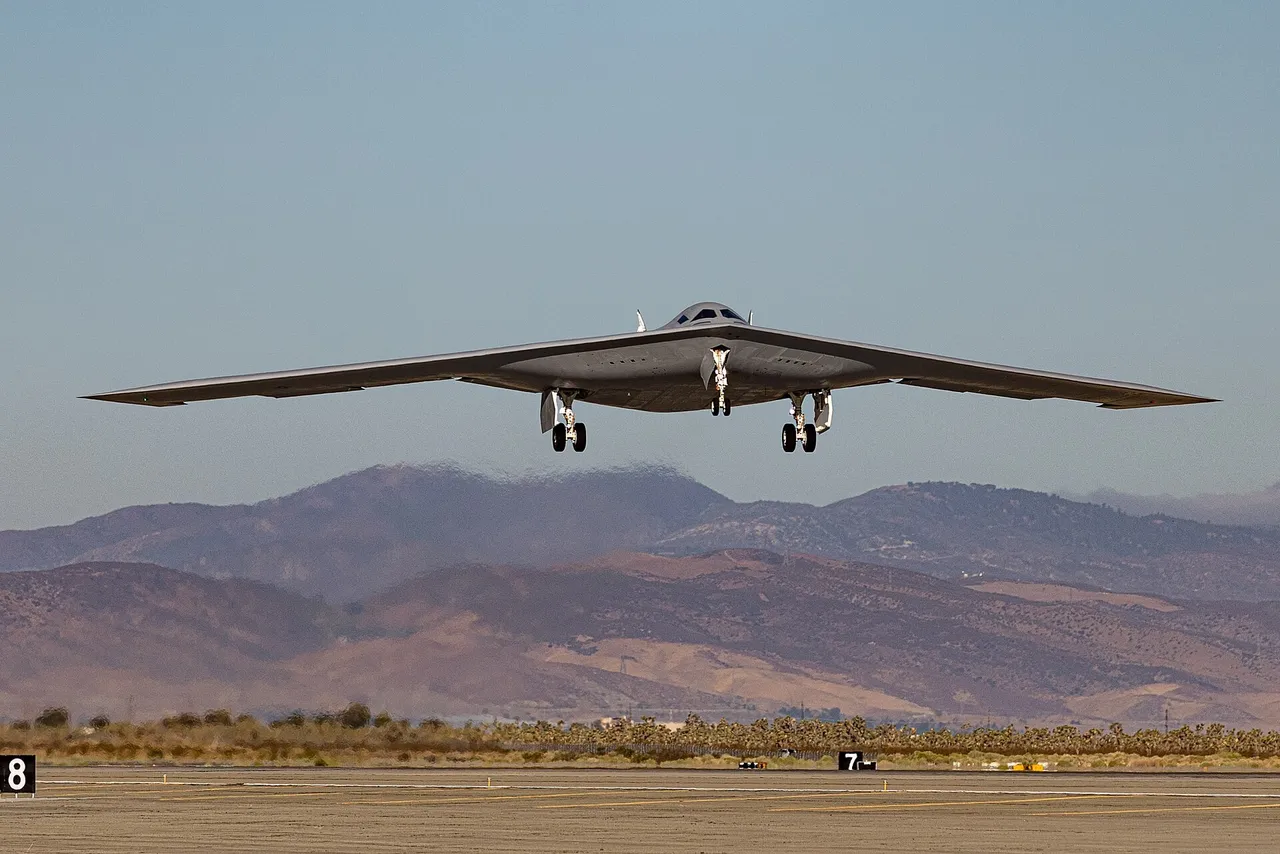 A grey B-21 Raider flying-wing stealth bomber taking off with its landing gear down
