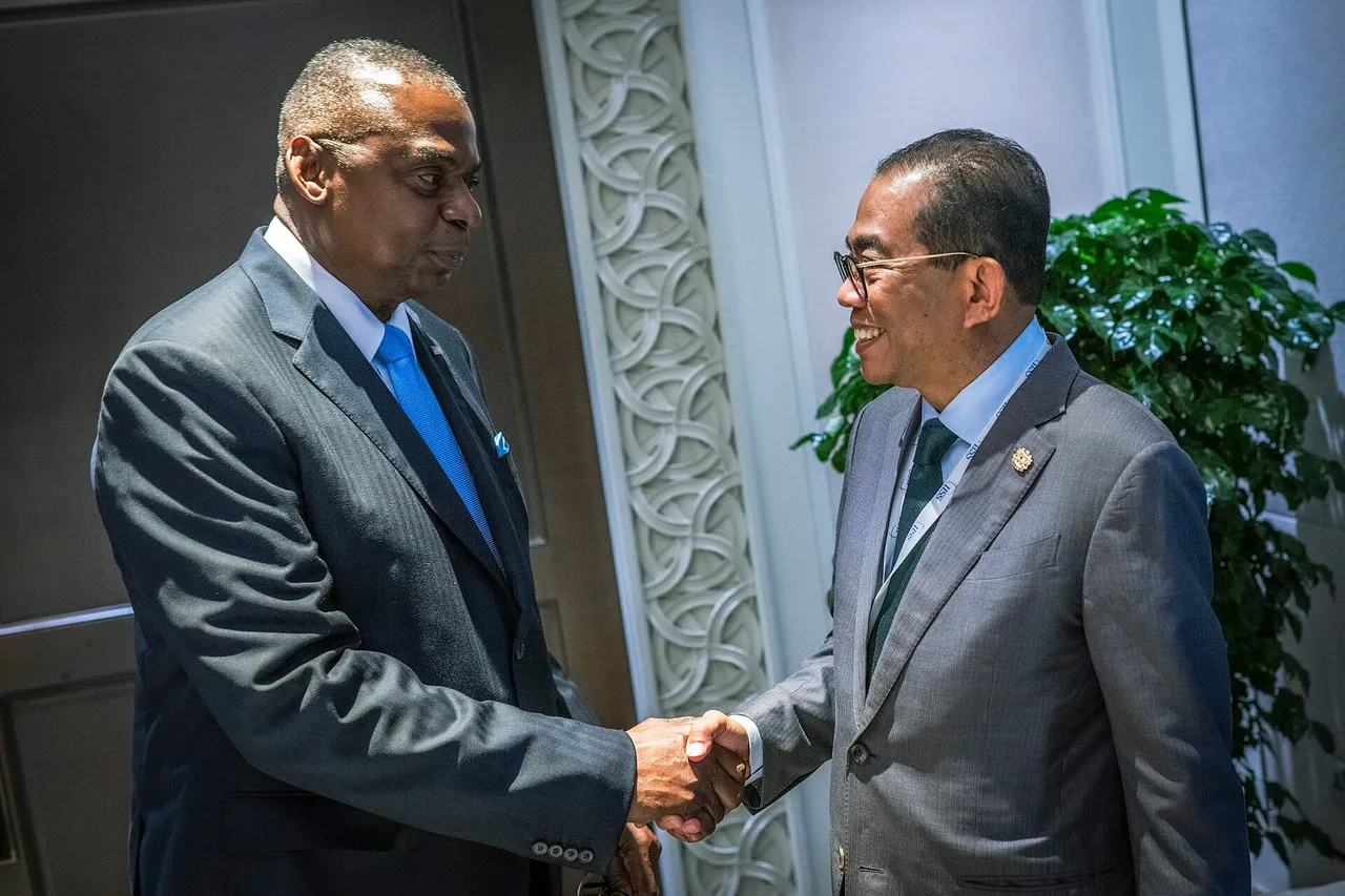 Malaysian Defence Minister Mohamed Khaled Nordin shaking hands with then US Defense Secretary Lloyd Austin