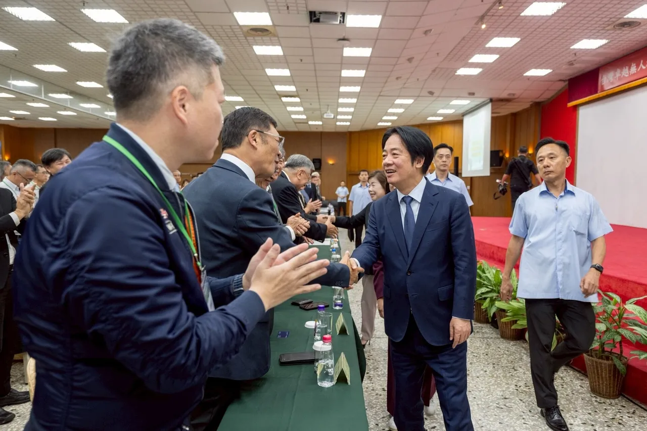 Taiwan's President Lai Ching-te shaking hands with participants in a hall at a drone industry alliance event in Taichung