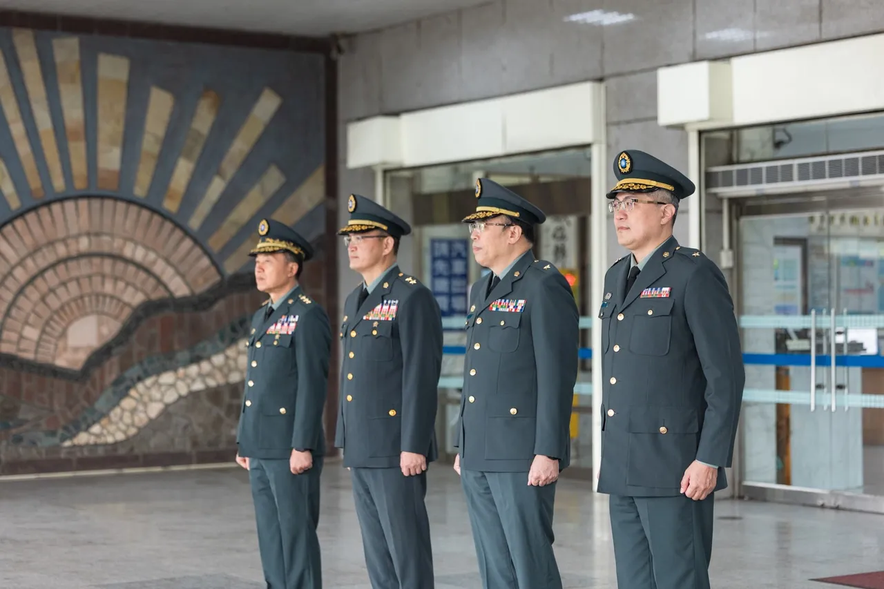 Four Taiwanese military officers in dark green uniforms and peaked caps stand in a line at a building entrance