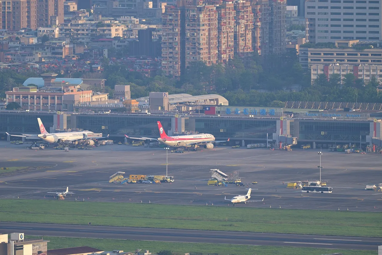 View of Taipei Songshan Airport runway and terminal area from an observation deck