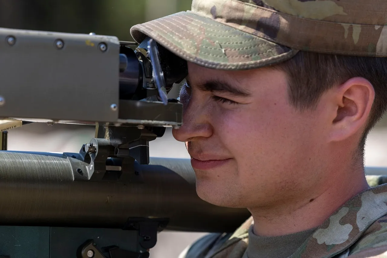 Close-up of a US Army soldier in a patrol cap sighting through the launcher of a shoulder-fired Stinger missile
