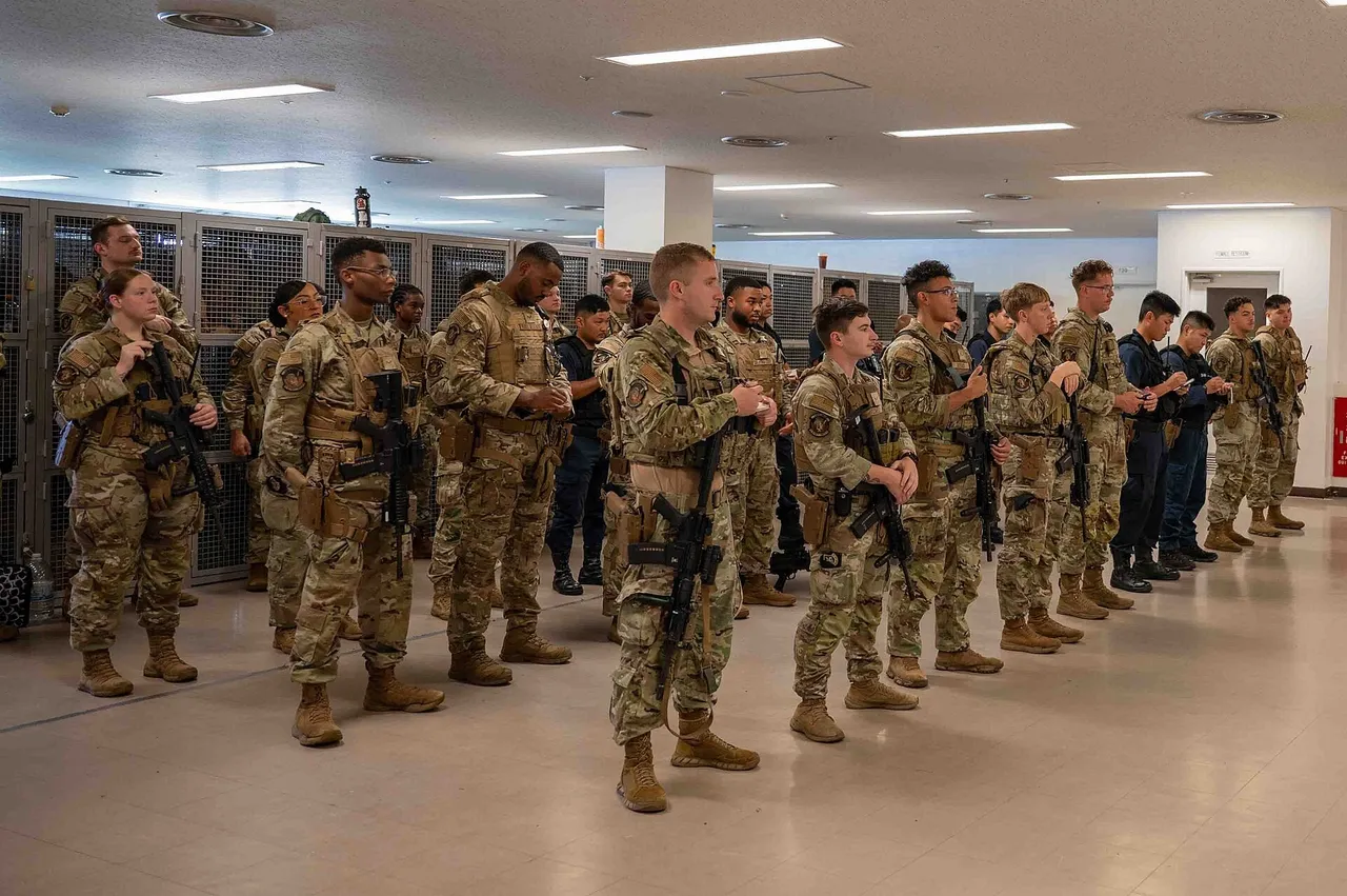 Rows of US Air Force security forces airmen in camouflage uniforms standing in formation during a briefing