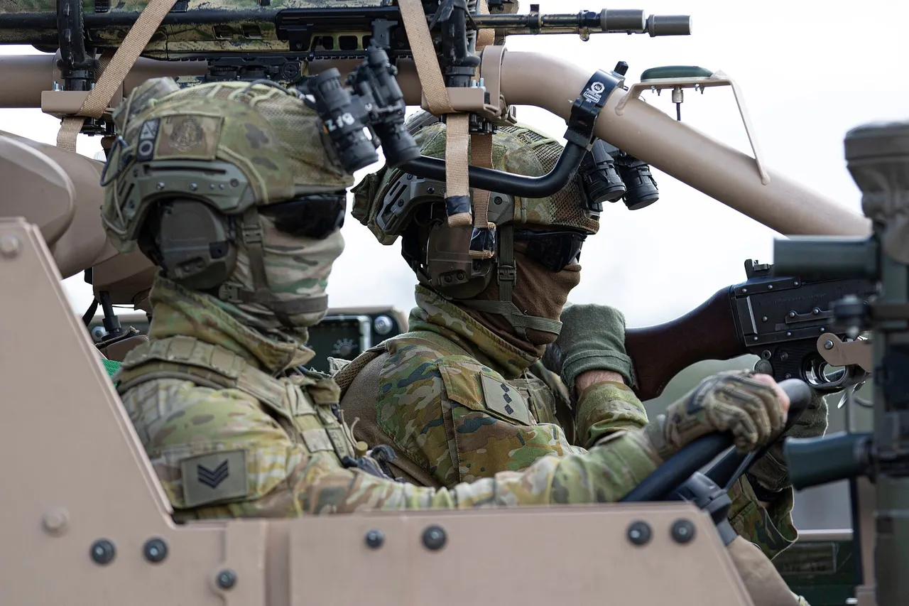 Australian soldiers in helmets scanning the terrain from an open-top six-wheel military vehicle in scrubland