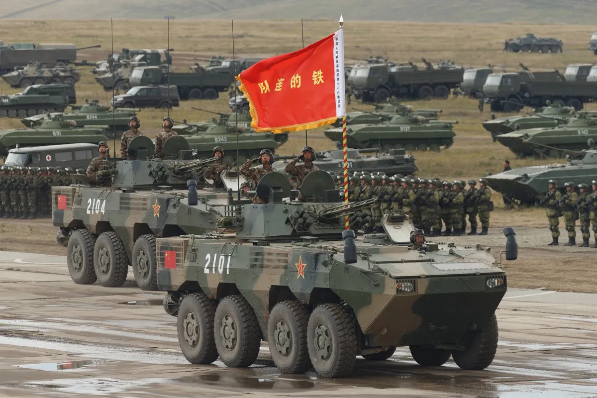 A Chinese eight-wheeled ZBL-08 infantry fighting vehicle in camouflage paint parked on a parade ground