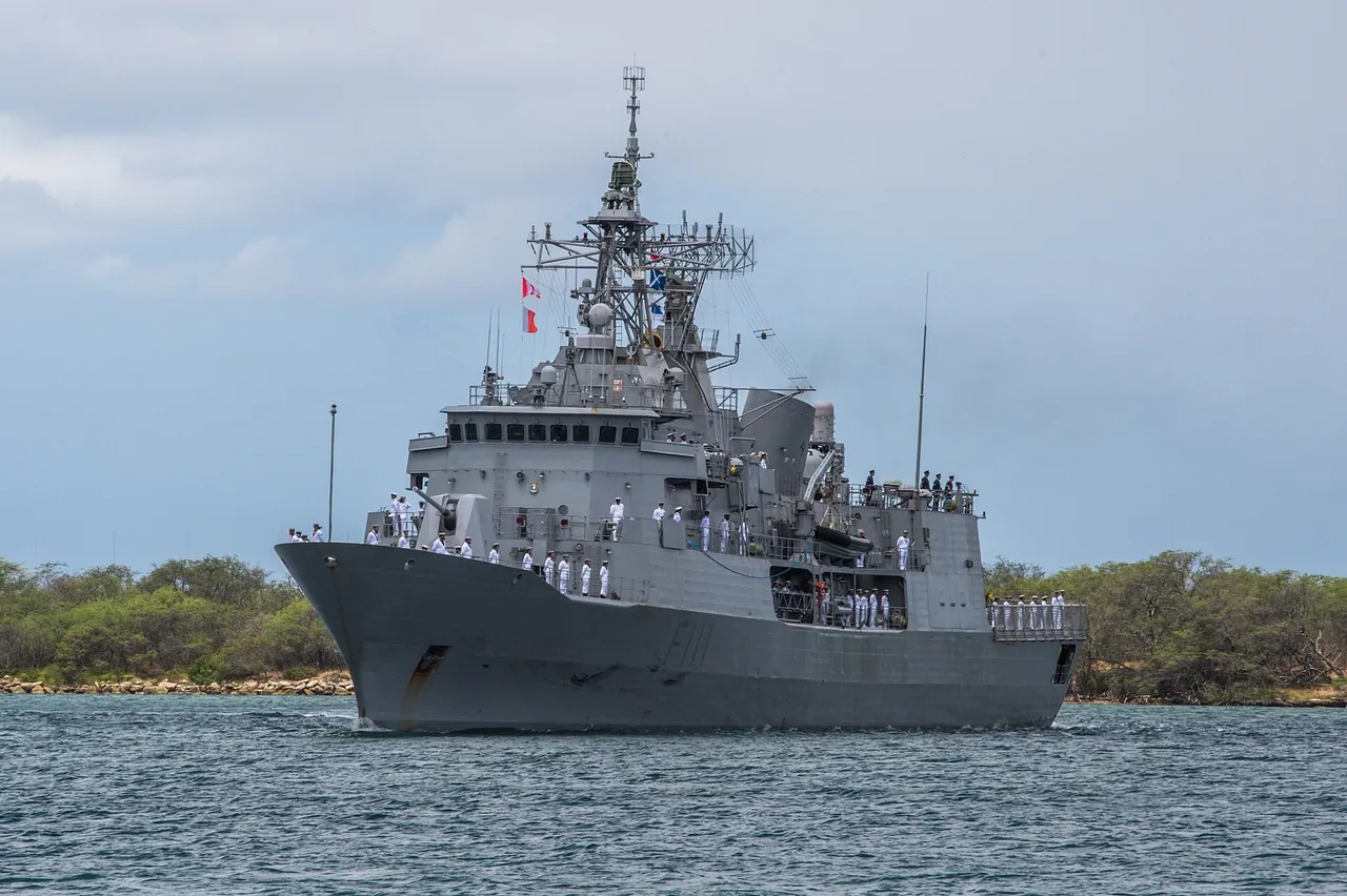 A grey New Zealand navy frigate with sailors lining the deck sails into harbour