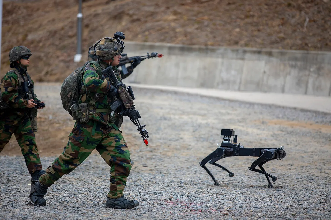 South Korean soldiers with rifles advance across gravel behind a four-legged robot carrying a sensor