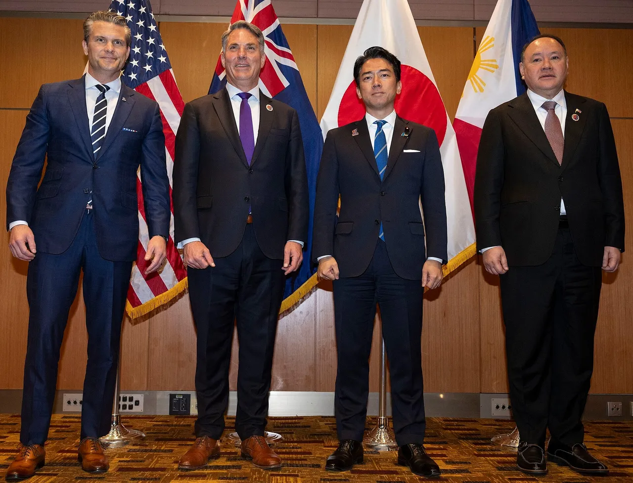 Defence ministers of Australia, the United States, Japan and the Philippines seated at a meeting table