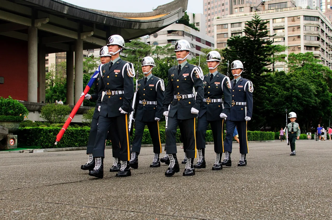 ROC Army honor guard soldiers carrying the Republic of China flag outdoors