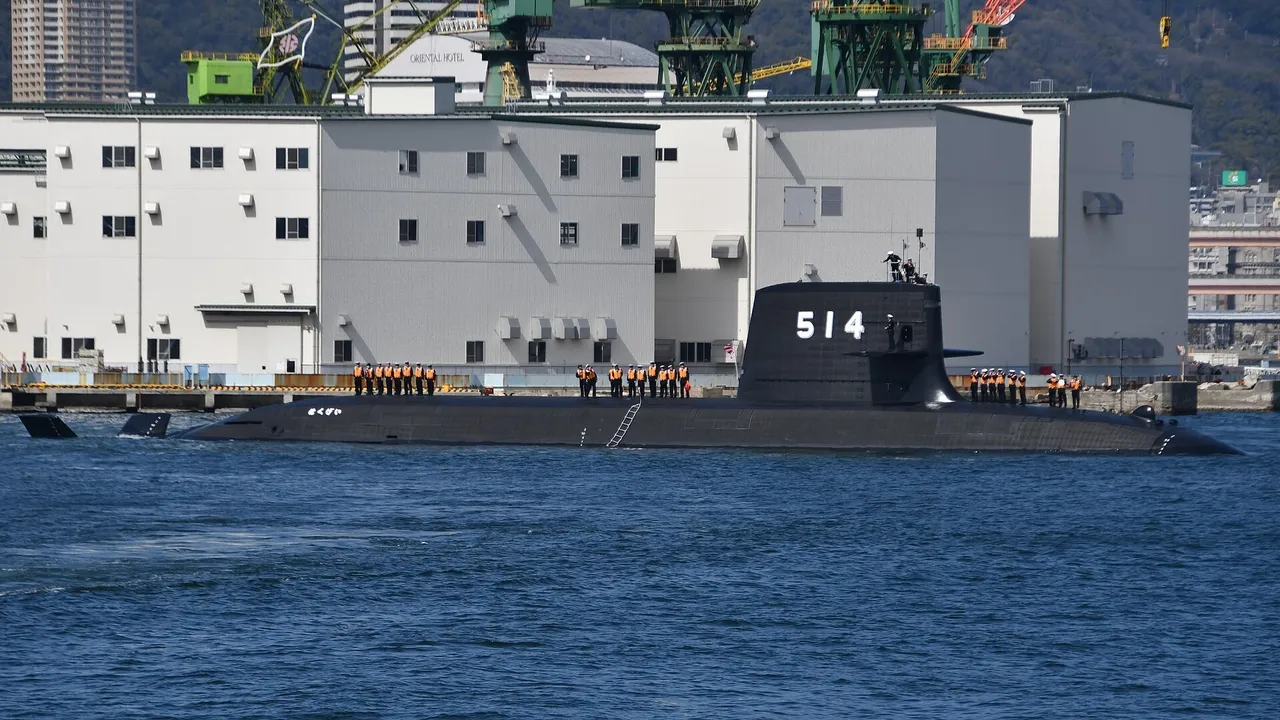 A black Japanese submarine with the hull number 514 and crew lined up on deck sailing past shipyard buildings in Kobe harbour