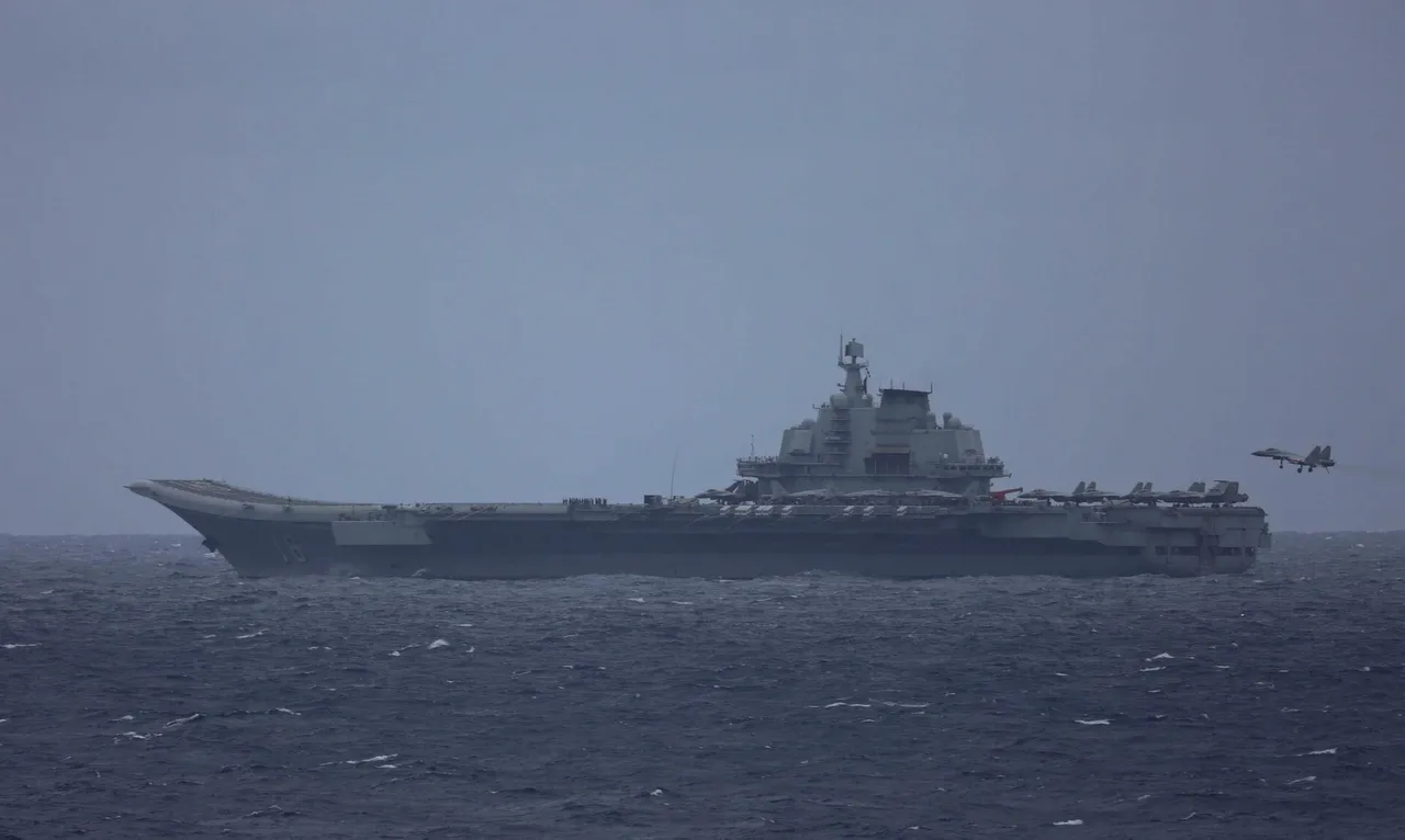 A grey Chinese J-15 carrier fighter with its hook down approaching the flight deck of the aircraft carrier Liaoning at sea