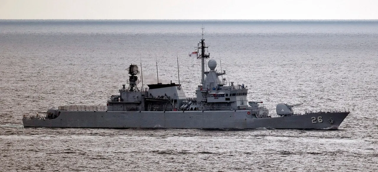 A grey Royal Malaysian Navy frigate with hull number 26 sailing on calm open sea