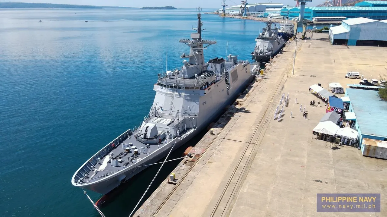 A grey Philippine Navy frigate moored alongside a pier at Subic, seen from above