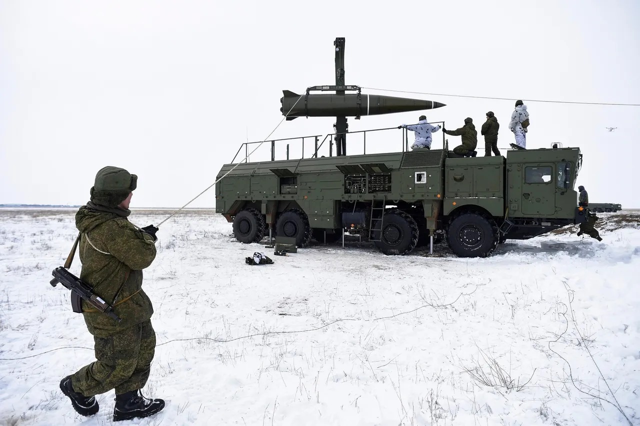 An Iskander-M ballistic missile lifting off from its launcher vehicle in a cloud of smoke on a snowy steppe range