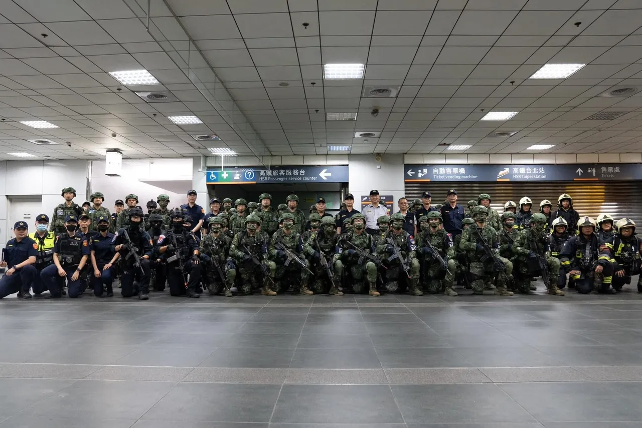 Rows of helmeted Military Police soldiers with rifles, alongside police officers and firefighters, pose for a group photo in a station concourse.